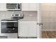 A modern kitchen with stainless steel appliances and light countertops at 8516 Polston Place Dr, Douglasville, GA 30134