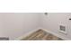 Well-lit laundry room featuring wood-look floors and utility hookups at 8516 Polston Place Dr, Douglasville, GA 30134