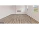 Large living room features sleek hardwood flooring and a modern fireplace, perfect for relaxation at 8516 Polston Place Dr, Douglasville, GA 30134