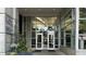 Main entrance of the building, featuring glass doors and signage for local businesses at 943 Peachtree Ne St # 704, Atlanta, GA 30309
