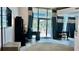 Bright living room with an office setup and sliding glass doors to the outside at 943 Peachtree Ne St # 704, Atlanta, GA 30309