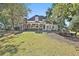 View of the sprawling backyard with a covered patio and outdoor kitchen at 160 Isleworth Way, Fayetteville, GA 30215