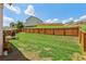 Spacious fenced backyard with lawn and small wood deck at 1602 Renaissance Ne Dr, Conyers, GA 30012
