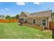 Lawn view of backyard featuring garden beds, small wood deck and screened-in porch at 1602 Renaissance Ne Dr, Conyers, GA 30012