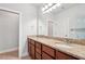 Bathroom with granite countertops, double sinks and a large mirror, plus a shower with glass door at 1602 Renaissance Ne Dr, Conyers, GA 30012