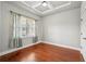Cozy bedroom with tray ceiling, hardwood floors, and bright window at 1602 Renaissance Ne Dr, Conyers, GA 30012
