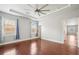 Spacious bedroom featuring hardwood floors, natural light and tray ceiling with a ceiling fan at 1602 Renaissance Ne Dr, Conyers, GA 30012