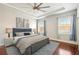 Spacious bedroom featuring a tray ceiling, large windows, and stylish decor at 1602 Renaissance Ne Dr, Conyers, GA 30012