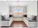 Bright breakfast nook with custom bench seating, storage, and a modern light fixture at 1602 Renaissance Ne Dr, Conyers, GA 30012