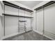 Walk-in closet with custom shelving, clothing racks, and carpet at 1602 Renaissance Ne Dr, Conyers, GA 30012