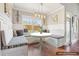 Bright dining nook with bench seating, modern light fixture, and backyard view at 1602 Renaissance Ne Dr, Conyers, GA 30012