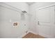 Functional laundry room with shelving, tile flooring, and an exterior door at 1602 Renaissance Ne Dr, Conyers, GA 30012