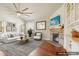 Bright, staged living room with fireplace, plush sofa, and large area rug at 1602 Renaissance Ne Dr, Conyers, GA 30012