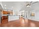 Open-concept living area with hardwood floors, a large island, and stainless steel appliances at 1602 Renaissance Ne Dr, Conyers, GA 30012
