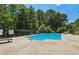 Community pool with sunbathing area and mature trees at 1602 Renaissance Ne Dr, Conyers, GA 30012