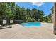 Community pool with sunbathing area and mature trees at 1602 Renaissance Ne Dr, Conyers, GA 30012