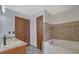 Bathroom offers a double vanity and luxurious soaking tub at 2520 Waterford Park Dr, Lawrenceville, GA 30044