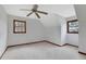 Spacious carpeted bedroom features two windows and a ceiling fan at 2520 Waterford Park Dr, Lawrenceville, GA 30044