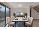 Elegant dining room with modern table setting, large windows, and access to outdoor deck space at 2520 Waterford Park Dr, Lawrenceville, GA 30044