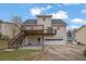 Back exterior view of the home features a deck and two-car garage at 2520 Waterford Park Dr, Lawrenceville, GA 30044