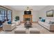 Bright living room with a cozy fireplace, neutral furniture, and large windows offering ample natural light at 2520 Waterford Park Dr, Lawrenceville, GA 30044