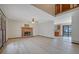 Open-concept living room with a brick fireplace, light wood floors, and a view of the kitchen area at 2520 Waterford Park Dr, Lawrenceville, GA 30044