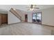 Large living room with light wood floors, staircase, and natural light streaming through the sliding glass door at 2520 Waterford Park Dr, Lawrenceville, GA 30044