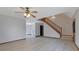 Bright living room featuring hardwood floors, a ceiling fan, and a staircase to the second floor at 2520 Waterford Park Dr, Lawrenceville, GA 30044