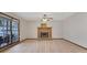 Bright living room featuring a brick fireplace, light wood floors, and large windows for natural light at 2520 Waterford Park Dr, Lawrenceville, GA 30044