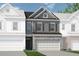 Charming townhouse showcasing a stone facade, two-car garage, and neutral gray tones at 2565 Ravencliff Dr # 74, Austell, GA 30168