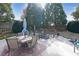 Large backyard with a patio, outdoor seating, fire pit, trampoline, and green grass at 1023 Spruce Creek Ln, Lawrenceville, GA 30045