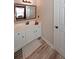 Bright bathroom features a white vanity with a large mirror and wood-look flooring at 1023 Spruce Creek Ln, Lawrenceville, GA 30045
