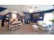 Spacious, well-lit bedroom with blue walls, vaulted ceiling, and cozy furniture at 1023 Spruce Creek Ln, Lawrenceville, GA 30045