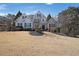 Beautiful two-story home with a manicured lawn, mature trees, and a welcoming entryway at 1023 Spruce Creek Ln, Lawrenceville, GA 30045