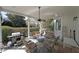 Covered outdoor patio includes comfortable seating, a ceiling fan and a grill at 1023 Spruce Creek Ln, Lawrenceville, GA 30045