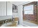 Cozy bathroom with brick accents, a granite counter, and white fixtures at 24 Daniel St # 6, Atlanta, GA 30312