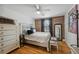 Bedroom with exposed brick, hardwood floors, ceiling fan, and dresser at 24 Daniel St # 6, Atlanta, GA 30312