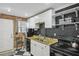 Updated kitchen with granite counters, black appliances, and white cabinets at 24 Daniel St # 6, Atlanta, GA 30312