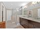 Bathroom featuring double vanity, walk-in glass shower, and neutral color palette at 4144 D Youville Trce, Atlanta, GA 30341