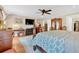 Spacious bedroom featuring a four-poster bed, hardwood floors, and a ceiling fan at 4144 D Youville Trce, Atlanta, GA 30341