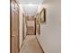 Hallway with carpet flooring and art-adorned walls leading to the staircase at 4144 D Youville Trce, Atlanta, GA 30341