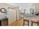 Bright kitchen featuring stainless steel appliances, granite countertops, a tiled backsplash, and wood floors at 4144 D Youville Trce, Atlanta, GA 30341