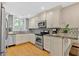 Well-lit kitchen featuring stainless steel appliances and granite countertops at 4144 D Youville Trce, Atlanta, GA 30341