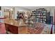 Open-concept living area with desk, bookshelves, seating, and elegant hardwood floors at 4144 D Youville Trce, Atlanta, GA 30341