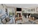 Comfortable living room with a fireplace, piano, and sliding door access to the deck at 4144 D Youville Trce, Atlanta, GA 30341