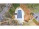 Aerial view of a covered in-ground swimming pool surrounded by mature trees, landscaping, and hardscape at 4144 D Youville Trce, Atlanta, GA 30341