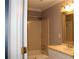 Bathroom featuring a vanity with light fixtures and a bathtub with shower at 711 Cypress Pointe St, Johns Creek, GA 30022