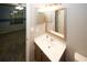 Bathroom vanity with classic fixtures, mirror, and view to the bedroom at 711 Cypress Pointe St, Johns Creek, GA 30022