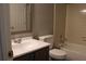 Bathroom featuring a bathtub with shower, toilet, and vanity with classic fixtures and tiles at 711 Cypress Pointe St, Johns Creek, GA 30022