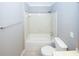 Clean bathroom featuring tiled bathtub, modern toilet, and updated vanity at 711 Cypress Pointe St, Johns Creek, GA 30022